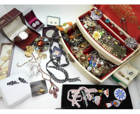 A collection of vintage costume jewellery to include a selection of dog brooches, items by Miracle, and First Nation beadwork