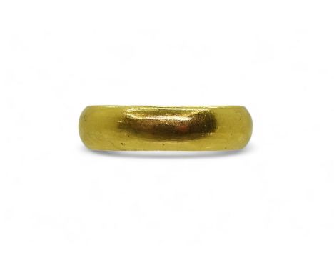 A bright yellow metal wedding ring, stamped with Chinese characters, size X1/2, weight 15.2gms Condition Report:Available upo