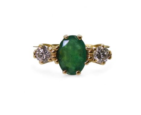 An 18ct gold emerald and diamond three stone ring, set with two 0.10ct brilliant cut diamonds, emerald approx 7mm x 5mm x 2.5