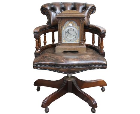 A 20th century buttonback upholstered revolving captains style desk chair, 84cm high x 62cm wide x 70cm deep and an oak mantl