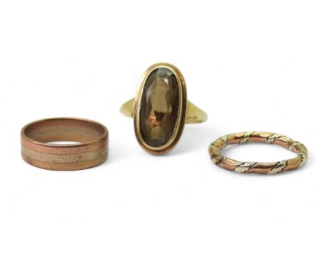 A 9ct bi colour wedding ring, size N, a three colour wedding ring, O1/2, and a 9ct smokey quartz ring, size O1/2, weight toge