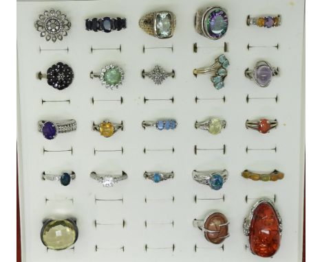 Twenty one silver gem set rings to include, two diamond cluster rings, one in the shape of a sunflower, large mystic topaz, A