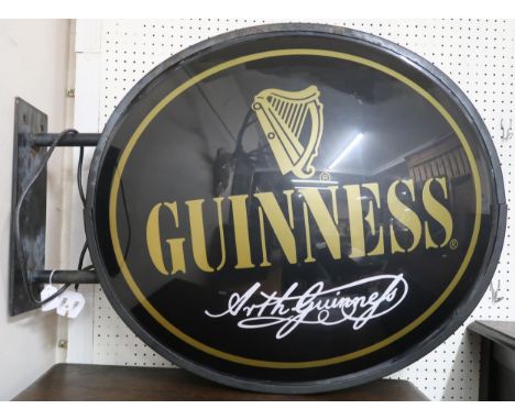 A 20th century 'Guinness' light up advertising bar sign with double sided oval placard on steel mounting bracket, 69cm high x