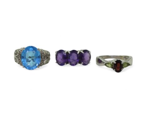 Two 9ct white gold gem set rings, amethyst size N1/2, garnet and peridot, size O, white gold blue topaz and diamond ring size