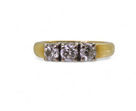 An 18ct gold three stone diamond ring, set with estimated approx 0.75cts, finger size K1/2, weight 5.5gms Condition Report:Av