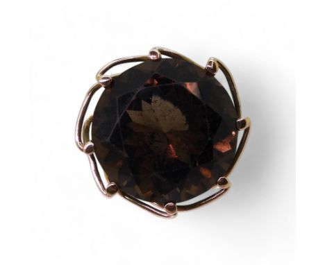 A 14k gold smokey quartz ring, with a decorative mount, size O1/2, weight 8.8gms Condition Report:Available upon request