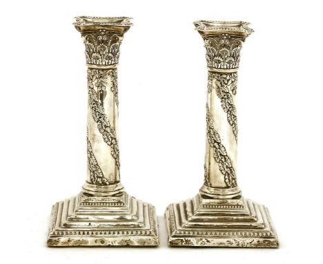 A pair of Edwardian corinthian column candlesticks, Walter Latham and Son, Sheffield, 1906, decorated with trailing leaf and 