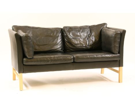 A Danish black leather two seater sofa, by 'Skippers', label underneath, 157cm wide, 76cm deep, 76cm high