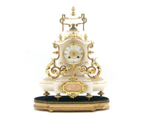 A late 19th Century alabaster and gilt metal clock, in the rococo style with an urn finial and applied gilt foliage and flora