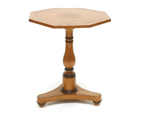A Biedermeier satin birch centre table, the octagonal top with a central star inlay in walnut, within segmented veneers, on a