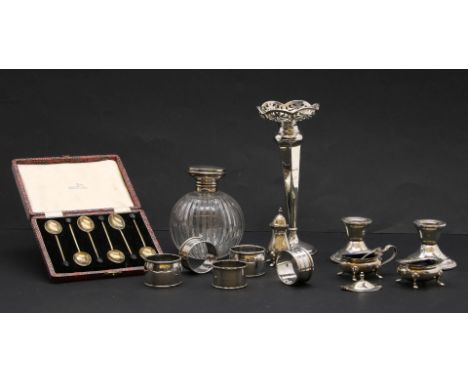 A cased set of six gilt and enamel coffee spoons, together with a silver bud vase, a silver topped scent bottle and other sil