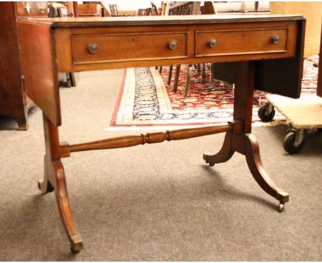 A mahogany sofa table, in the George III style, on sabre legs, united by a turned stretcher, 92cm wide, 60cm deep, 75cm high