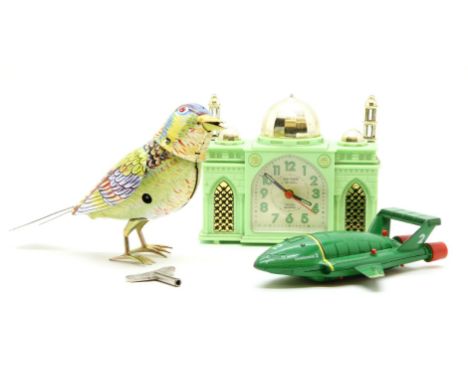 A Matchbox model of Thunderbird 2, together with a clockwork tin plate model of an exotic bird, and a mantel clock in the for