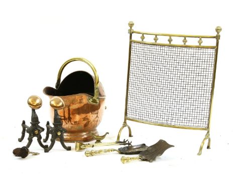 A copper coal scuttle, with large brass coat of arms, a spark guard, a pair of fire irons and tools