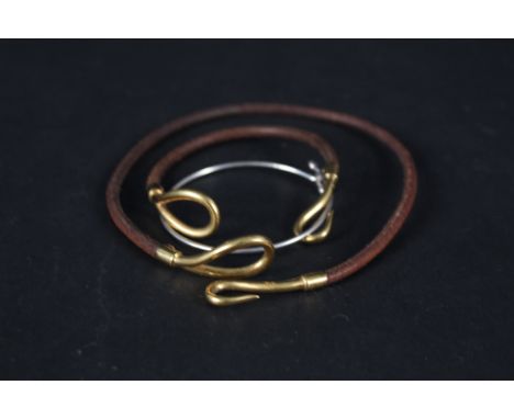 A matching Hermes cord and yellow metal necklace, bracelet set together with a silver Tiffany &amp; Co bangle