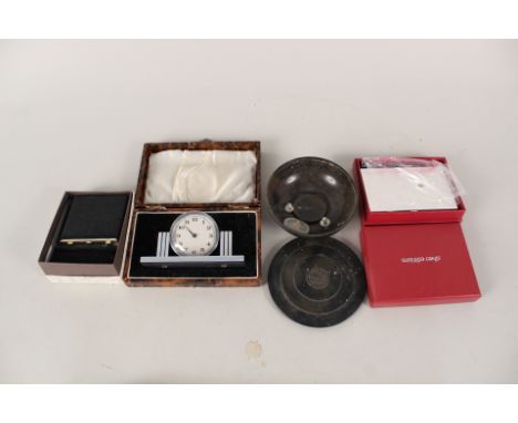 An Art Deco style bedside clock in fitted box, a Bakelite 'Morny' lidded pot, a Stratton compact and notebook etc