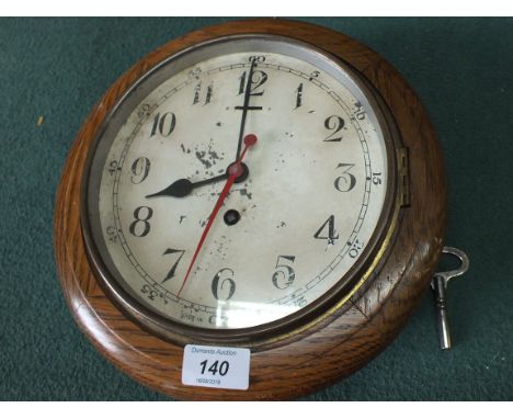 An oak cased circular dial clock