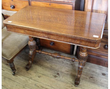 A 19th Century oak card table with stretcher base