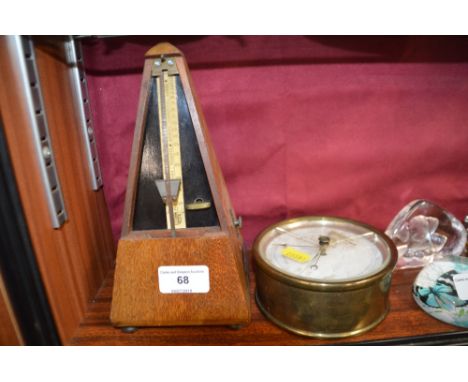 A brass cased barometer AF; and an mahogany cased metronome (lacking cover)