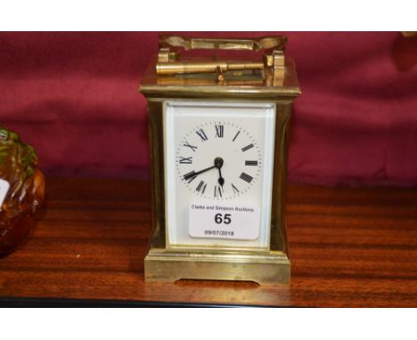 A brass cased carriage clock and key
