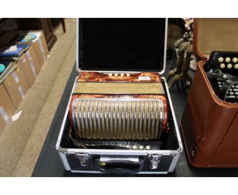 A Hohner Erica accordion in fitted case