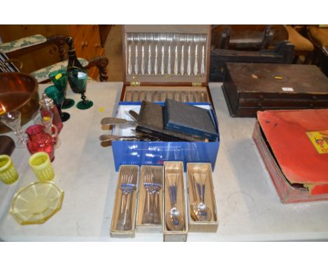 A cased set of silver plated knives and forks contained in walnut box; together with a box of various cutlery to include a la