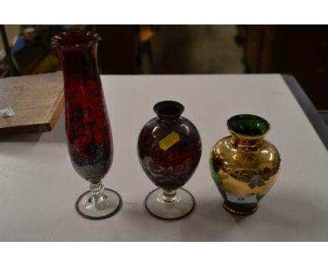 Two ruby and silver overlaid glass vases; together with a green glass overlaid vase 