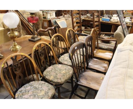A pair of elm seated stick back kitchen chairs and one other chair 