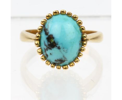 A single stone turquoise ring, in yellow metal stamped 18ct, ring size M