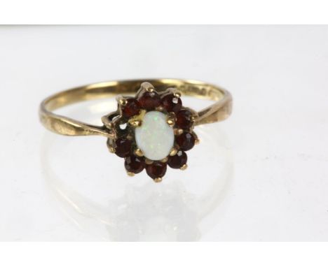 Opal and garnet cluster ring in stamped 9ct, ring size S, 1.9 gramsCondition Report:  one stone missing