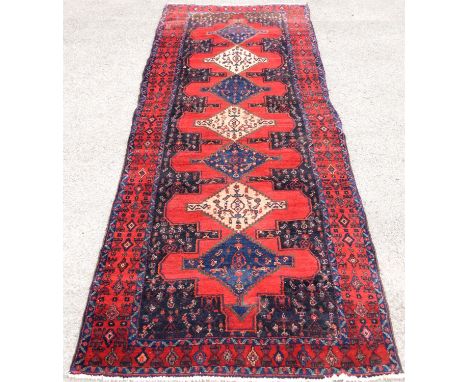 Persian Naravan Runner, heavy pile, with six medallions on a red ground, 348 x 123cm Condition Report:  Fringes are trimmed. 