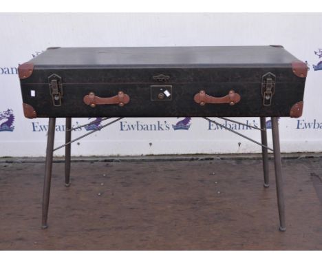 A leather trunk raised on metal base 125cm wide x 45cm deep x 84cm high.