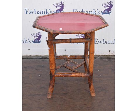 A bamboo framed octagonal occasional table with moveable shelf below over shelf. 65cm wide x 65 cm deep x 72 cm high,