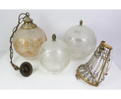 Three etched glass light shades of graduated sizes, with pineapple brass finials, tallest 31cm high, with two globular hangin