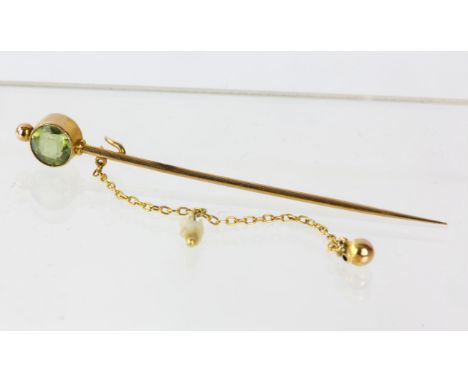 Peridot set stick pin brooch with ball and safety chain, in tested 14ct, length 60mm, 1.6 grams