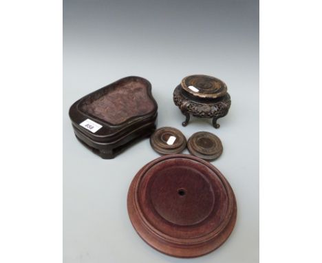 A collection of Chinese hardwood stands including a 19thC Chinese example to fit a jade boulder 