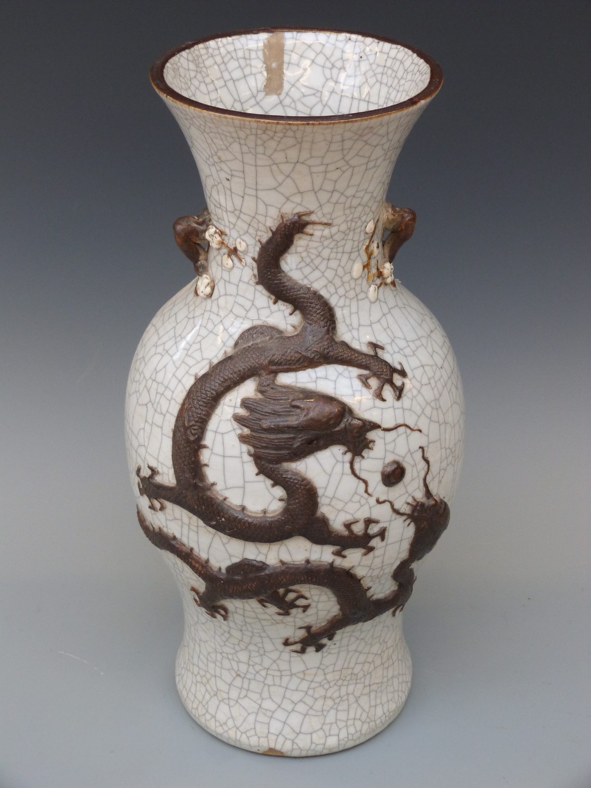 A Chinese crackle glazed vase with relief modelled dragon decoration