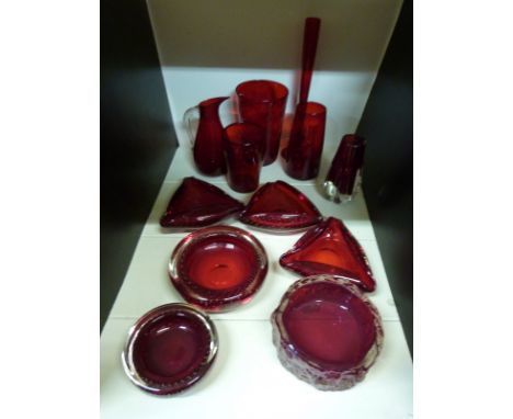 A collection of Whitefriars and similar ruby glassware including a textured bark dish, control bubble dishes, waved vase etc