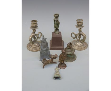 A pair of cast metal figural chambersticks, an Indian brass figure of a traveller, a bronze nude on plinth, brass bell etc