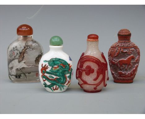 Four Chinese scent bottles comprising ceramic with green dragon decoration, Beijing overlaid cameo glass, reverse painted gla