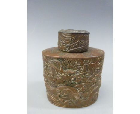 A Japanese bronzed tea caddy with embossed dragon decoration 11cm tall