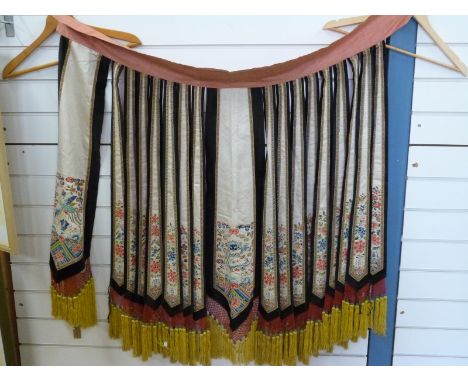 An early 20thC Chinese silk cloak made up of individual segments embroidered with chrysanthemums and butterflies, the central