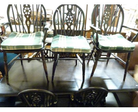 An Ercol 6+2 dining suite (table H76 x L183 x W82)