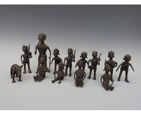 A group of thirteen African brass figures depicting hunting, mother and child, animals etc all with chequered design, largest
