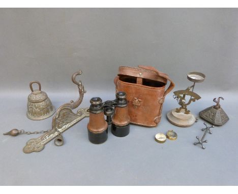 A 19thC cast iron kentish paperweight, brass postage scales and a hanging bell with bracket in the Tibetan style, field glass