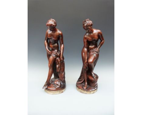 A pair of plaster bronze-effect figures of semi-nude bathing ladies after Falconnet, (57cm tall)