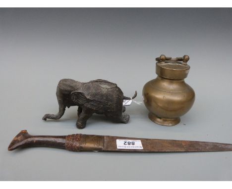 A Nepalese or Tibetan bronze elephant, tribal knife and a bronze or brass pot