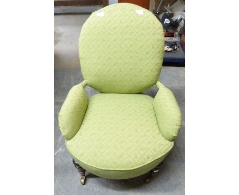 A 19thC Victorian nursing chair raised on ceramic and brass castors 