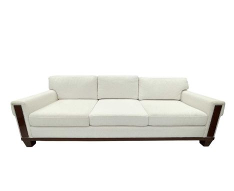 Superyacht furnishings, a contemporary four/five seater sofa with white boucle fabric.  On a highly laquered wood veneered ba