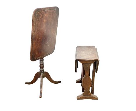 A George IV mahogany tilt top table. A rectangular top, on tripod legs, with a turned central column, height 68cm, width 59cm